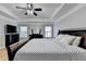 Spacious bedroom with a ceiling fan, natural lighting, and stylish furnishings at 2425 Delamore Chase, Duluth, GA 30097