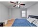 Bedroom features hardwood floors, a window and modern ceiling fan at 2425 Delamore Chase, Duluth, GA 30097
