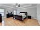 Primary bedroom with hardwood floors, tray ceilings, and ample natural light at 2425 Delamore Chase, Duluth, GA 30097