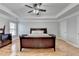Bedroom showcasing hardwood floors, ceiling fan, a dresser, and bedside tables at 2425 Delamore Chase, Duluth, GA 30097