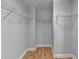 Walk-in closet with built-in shelving and hardwood floors at 2425 Delamore Chase, Duluth, GA 30097