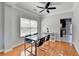 Bright dining area featuring hardwood floors, modern light fixture and view to the kitchen at 2425 Delamore Chase, Duluth, GA 30097