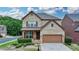 Charming two-story brick home featuring a well-manicured front lawn and an attached two-car garage at 2425 Delamore Chase, Duluth, GA 30097