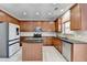 Spacious kitchen with a central island, stainless steel appliances, and tile floors at 2425 Delamore Chase, Duluth, GA 30097