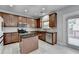 Well-equipped kitchen boasting stainless steel appliances, granite countertops, and a central island at 2425 Delamore Chase, Duluth, GA 30097