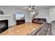 Bright living room featuring fireplace, large-screen TV, and staircase at 2425 Delamore Chase, Duluth, GA 30097