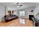 Open-concept living room featuring fireplace, large-screen TV, and view of kitchen at 2425 Delamore Chase, Duluth, GA 30097