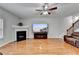 Open living area with fireplace and large-screen TV; hardwood floors and staircase to upper level at 2425 Delamore Chase, Duluth, GA 30097
