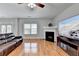 Living room with fireplace, flat-screen TV, hardwood floors, and plenty of natural light at 2425 Delamore Chase, Duluth, GA 30097