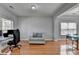 Spacious living room featuring hardwood floors, natural light, and seating area at 2425 Delamore Chase, Duluth, GA 30097