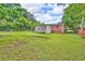 Lush backyard featuring a screened-in porch, brick facade, and mature trees, creating a private outdoor oasis at 3395 Spring Dr, Atlanta, GA 30360