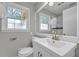 Bathroom featuring a white vanity, toilet, and a shower with decorative tiling at 3395 Spring Dr, Atlanta, GA 30360