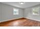 Neutral bedroom with hardwood floors and two windows at 3395 Spring Dr, Atlanta, GA 30360