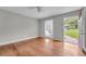 Empty bedroom featuring hardwood floors, neutral walls, and a view of the yard at 3395 Spring Dr, Atlanta, GA 30360