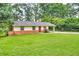 Charming single-story home featuring a well-manicured lawn, brick accents, and a convenient covered carport at 3395 Spring Dr, Atlanta, GA 30360