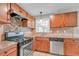 Traditional kitchen featuring stainless steel appliances, wood cabinets, and neutral countertops at 3395 Spring Dr, Atlanta, GA 30360