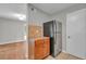 A kitchen area featuring wooden cabinets, stainless steel refrigerator, and adjacent wooden floors at 3395 Spring Dr, Atlanta, GA 30360