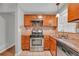 Traditional kitchen featuring stainless steel appliances, wood cabinets, and neutral countertops at 3395 Spring Dr, Atlanta, GA 30360