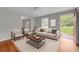 Cozy staged living room with hardwood floors, neutral furniture, and plenty of natural light from the front door at 3395 Spring Dr, Atlanta, GA 30360