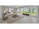 Bright sunroom with tile floors, neutral furniture, and large windows offering views of the outdoor green space at 3395 Spring Dr, Atlanta, GA 30360