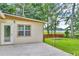 Home exterior with a concrete patio overlooking a grassy lawn and providing serene water views at 3395 Spring Dr, Atlanta, GA 30360
