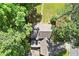 An aerial view of a beautiful home highlighting the roof, driveway, backyard patio, and surrounding greenery at 3999 Brintons Ml, Marietta, GA 30062