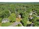 Aerial view of the home surrounded by lush trees in a neighborhood with green lawns and cul-de-sac streets at 3999 Brintons Ml, Marietta, GA 30062