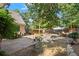 Brick patio and stone landscaping in the backyard, with a partially fenced lawn at 3999 Brintons Ml, Marietta, GA 30062