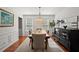 Elegant dining room with hardwood floors, decorative buffet, and pendant lighting fixture at 3999 Brintons Ml, Marietta, GA 30062