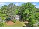 A two-story brick home with beautiful green shutters and a well-manicured lawn, surrounded by mature trees at 3999 Brintons Ml, Marietta, GA 30062