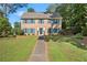 Charming brick home with blue shutters, mature trees, and a well-manicured lawn at 3999 Brintons Ml, Marietta, GA 30062