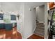 Inviting hallway with hardwood floors, stairway and easy access to the kitchen featuring blue cabinets and stainless appliances at 3999 Brintons Ml, Marietta, GA 30062