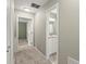 Hallway shows an entry into a bathroom with nice natural light and traditional vanity at 3999 Brintons Ml, Marietta, GA 30062