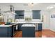 Bright kitchen with blue cabinets, stainless appliances, island, and gas range at 3999 Brintons Ml, Marietta, GA 30062