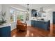 Sunlit eat-in kitchen with blue cabinets, breakfast nook, and stainless steel appliances at 3999 Brintons Ml, Marietta, GA 30062