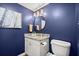 Stylish powder room with blue walls, granite countertop, and decorative wall art at 3999 Brintons Ml, Marietta, GA 30062