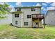 Home's backyard features a wooden deck, lawn and trees at 7760 Hansel Ln, Lithonia, GA 30058