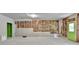 Spacious unfinished basement with painted green door and exposed studs at 7760 Hansel Ln, Lithonia, GA 30058
