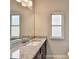 Bathroom boasts granite countertop vanity, modern fixtures, and natural light at 7760 Hansel Ln, Lithonia, GA 30058