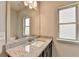 Bathroom with a granite countertop, decorative vanity, and a large mirror at 7760 Hansel Ln, Lithonia, GA 30058