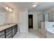 Bathroom with double vanity, tiled shower and soaking tub and entrance to walk-in closet at 7760 Hansel Ln, Lithonia, GA 30058