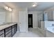Bathroom with double vanity, tiled shower and soaking tub and entrance to walk-in closet at 7760 Hansel Ln, Lithonia, GA 30058