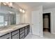 Bathroom with double vanity, tiled shower and soaking tub and entrance to walk-in closet at 7760 Hansel Ln, Lithonia, GA 30058