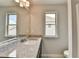 Granite vanity in bathroom with natural light streaming from two windows at 7760 Hansel Ln, Lithonia, GA 30058