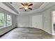 Spacious bedroom features tray ceilings, ceiling fan, and beautiful gray laminate flooring at 7760 Hansel Ln, Lithonia, GA 30058