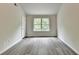 Bright bedroom with wood-look floors and a window view of the trees at 7760 Hansel Ln, Lithonia, GA 30058