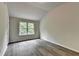 Bedroom with peaked ceiling and view of the outdoors from the window and gray laminate flooring at 7760 Hansel Ln, Lithonia, GA 30058