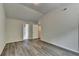 Vaulted bedroom with wood-look flooring and view to connected bath at 7760 Hansel Ln, Lithonia, GA 30058