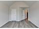 Bedroom featuring vaulted ceilings, wood-look flooring, and ample closet space at 7760 Hansel Ln, Lithonia, GA 30058
