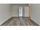 Neutral bedroom with wood-look flooring with openings to other rooms at 7760 Hansel Ln, Lithonia, GA 30058